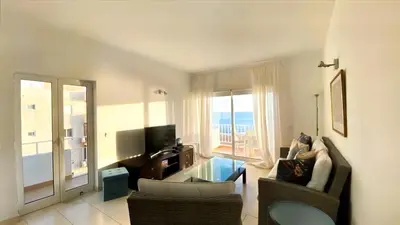a living room with a couch and chairs and a television at Frente praia SIM T3 Praia Quarteira by HsRentals in Quarteira