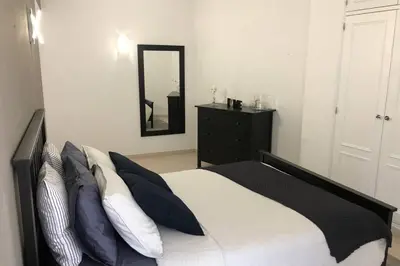 a bedroom with a bed and a dresser and a mirror at Le Modern' in Albufeira