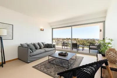 a living room with a couch and a table at Varandas do Castelo By Garvetur in Albufeira