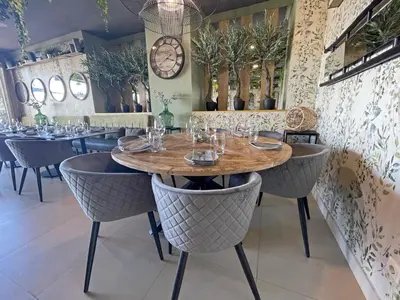 a dining room with a wooden table and chairs at Varandas do Castelo By Garvetur in Albufeira