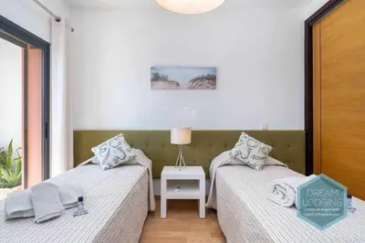 two beds sitting next to each other in a room at Terrace Miguel Torga - Dream Lodging in Albufeira