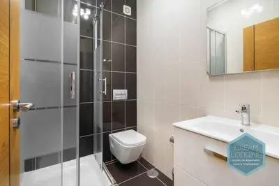 a bathroom with a shower and a toilet and a sink at Terrace Miguel Torga - Dream Lodging in Albufeira