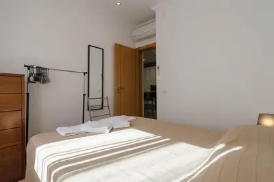 a bedroom with a bed with towels on it at De Hofnar Apartments Albufeira in Albufeira