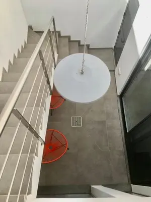 a room with a white table and a staircase at Casa dos Retratos Faro in Faro