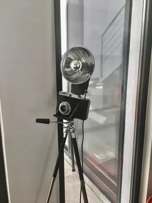 a camera on a tripod next to a window at Casa dos Retratos Faro in Faro