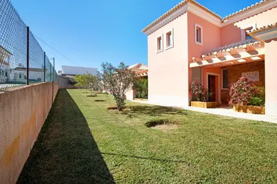 a backyard of a house with a fence at Casa Tulipas in Loulé