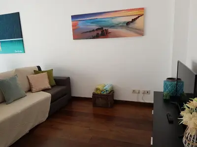 a living room with a couch and a painting on the wall at Villa beautiful View over the sea - T in Albufeira