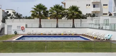 a large swimming pool with chairs and a building at Villa beautiful View over the sea - T in Albufeira