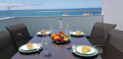 a table with plates of food and a bowl of fruit at Villa beautiful View over the sea - T in Albufeira