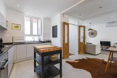 a kitchen with a table in the middle of a room at Casa Lobo - 2 bedrooms - Duplex in Faro