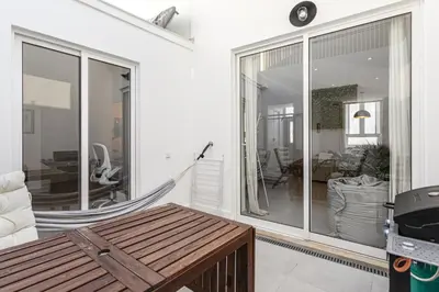 a room with a hammock and a living room at Casa Lobo - 2 bedrooms - Duplex in Faro