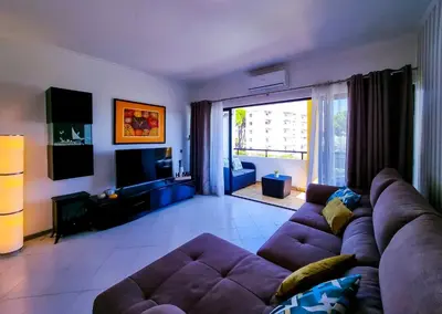 a living room with a purple couch and a large window at FLH Vilamoura Balcony with Pool in Vilamoura