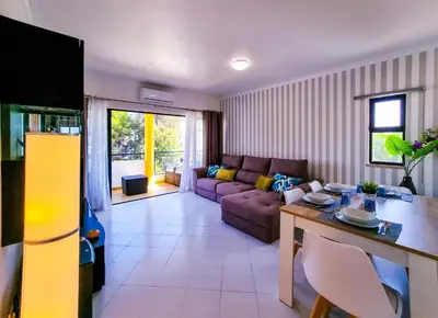 a living room with a couch and a table at FLH Vilamoura Balcony with Pool in Vilamoura
