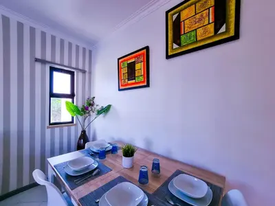 a dining room with a table with chairs at FLH Vilamoura Balcony with Pool in Vilamoura
