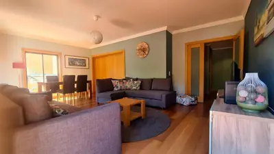 a living room with a couch and a table at 2 Terrace Town House in Albufeira