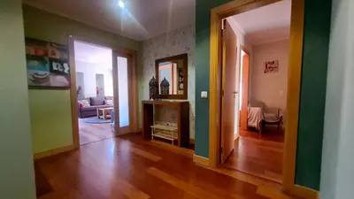 a living room with green walls and wooden floors at 2 Terrace Town House in Albufeira