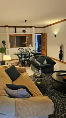 a living room with two couches and a table at Tivoli Apt8 with Pool&Garage in Vilamoura
