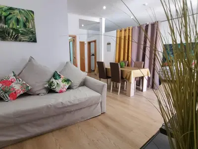 a living room with a couch and a table at Sun Apartment on the Beach in Albufeira
