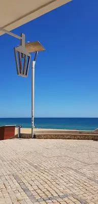 a street light with the beach in the background at Sun Apartment on the Beach in Albufeira