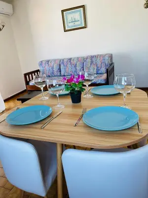 a bar in a restaurant with blue stools at Casa Do Canto in Albufeira