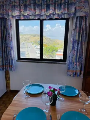 a dining room table with plates and wine glasses at Casa Do Canto in Albufeira