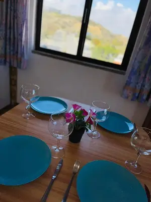 a wooden table with blue plates and glasses on it at Casa Do Canto in Albufeira