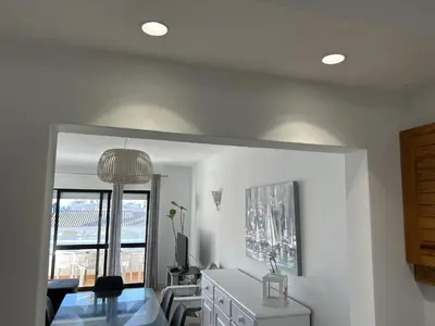 a white room with a table and a mirror at Velamar Praia 411 - 300m da praia in Albufeira