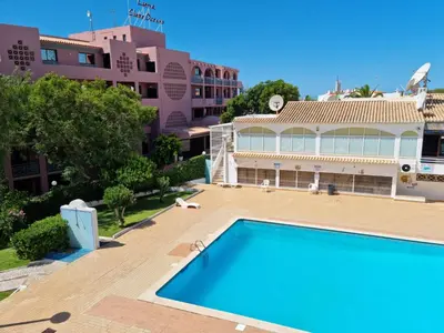 a view of a swimming pool in front of a building at Velamar Praia 411 - 300m da praia in Albufeira