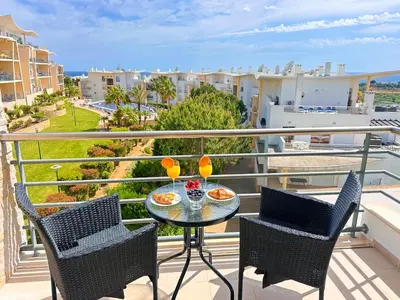 a living room with blue towels on a couch at AlbufeiraOrada SunSet Penthouse by Be Cherish in Albufeira