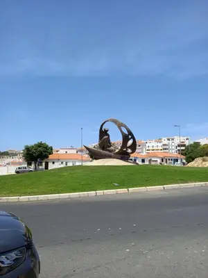 a statue on the side of a road next to a street at Villa Amazing View - S in Albufeira