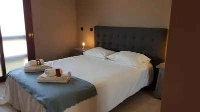 a bedroom with a large bed with towels on it at Algarve Paraíso / Golf Vila Sól in Quarteira
