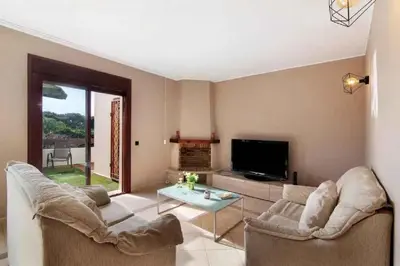a bedroom with a bed and a dresser and towels at Algarve Paraíso / Golf Vila Sól in Quarteira