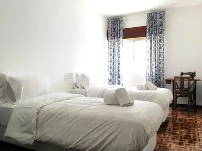 a bedroom with two beds and a window at Lemon Tree Apartments in Faro