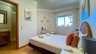 a bedroom with a bed and a large window at T3 Marina Sol Vilamoura by HsRentals in Vilamoura