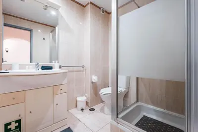 a bedroom with two beds with red sheets at Apartamentos Julieta in Albufeira