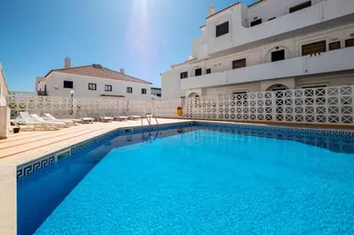 a bathroom with a toilet and a glass shower at #035 T2 Oura Village by Home Holidays in Albufeira