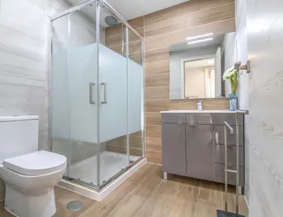 a bathroom with a shower with a toilet and a sink at #035 T2 Oura Village by Home Holidays in Albufeira