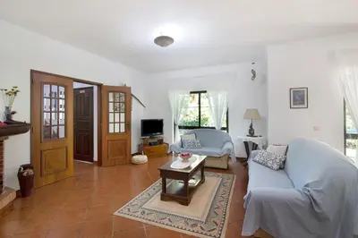 a living room with a couch and a table at Casa da Alfarrobeira in Loulé