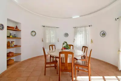 a dining room with a table and chairs at Casa do Barrocal in Almancil