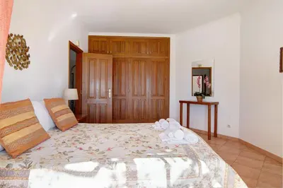 a bedroom with a large bed with towels on it at Casa do Barrocal in Almancil