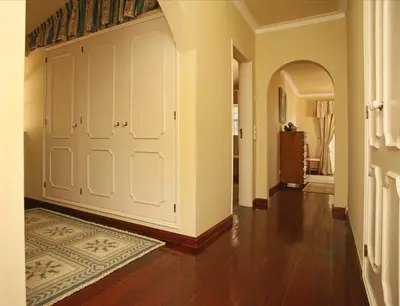 a hallway with a large white door and a rug at Villa Jumar in Albufeira