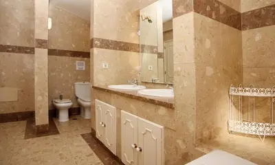 a bathroom with a toilet and a sink and a mirror at Villa Jumar in Albufeira
