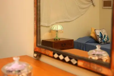 a bedroom with a mirror and a bed and a table at Villa Jumar in Albufeira