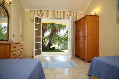 a bedroom with an open door to a yard at Villa Jumar in Albufeira
