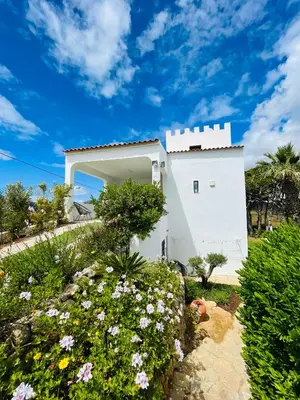 a white house with flowers in front of it at Vila Castelo in Vale do Lobo