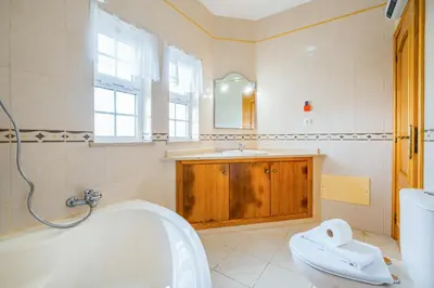 a bathroom with a tub and a toilet and a sink at Filomena Golf Paradise in Guia