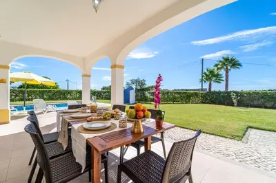 a dining room with a table and chairs at Filomena Golf Paradise in Guia