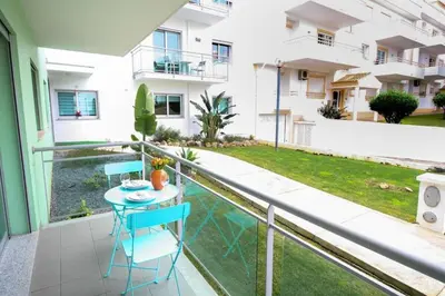 a balcony with a table and chairs on it at 2 Bed apartment with Roof Top Pool, close to Falesia Beach AT10 in Albufeira