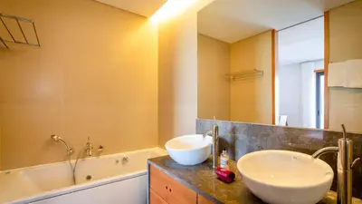 a bathroom with two sinks and a bath tub at Apartment Luisa in Vale do Lobo
