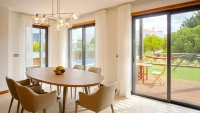 a dining room with a table and chairs at Apartment Luisa in Vale do Lobo